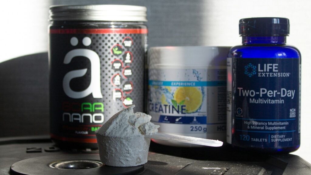 Supplement tubs, capsules and creatine on a table