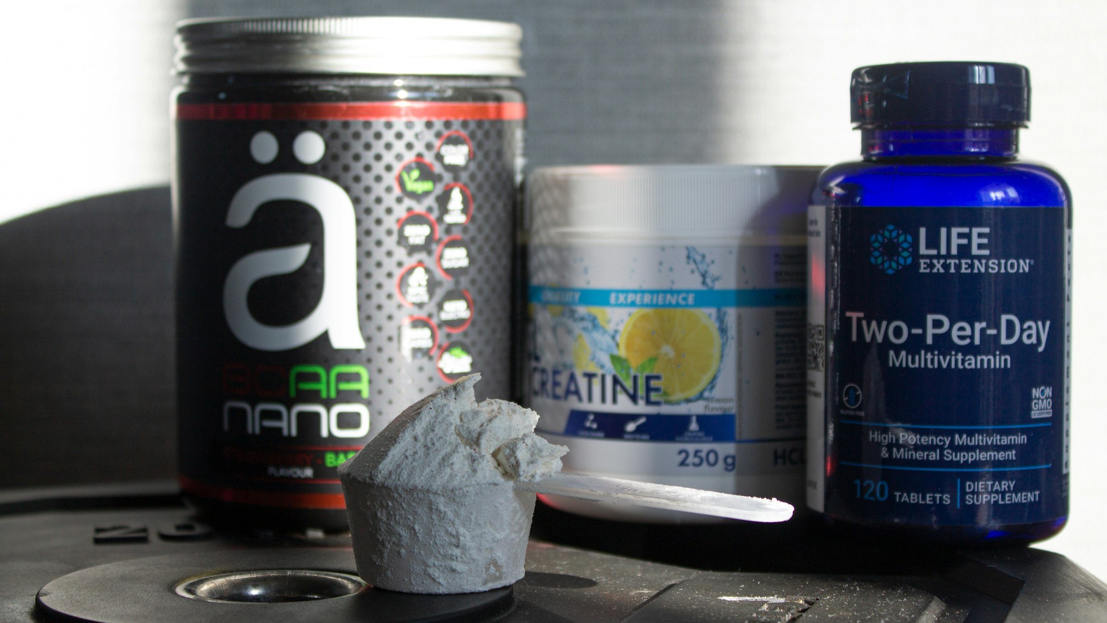 Supplement tubs, capsules and creatine on a table