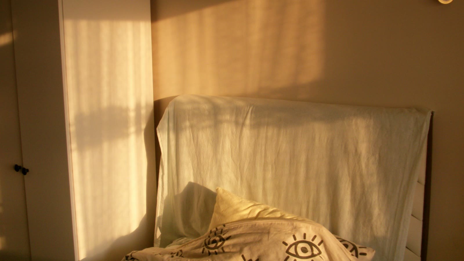 Warm morning light across a quiet bedroom