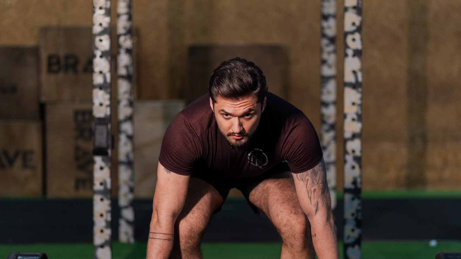 Man preparing to lift a barbell in a gym