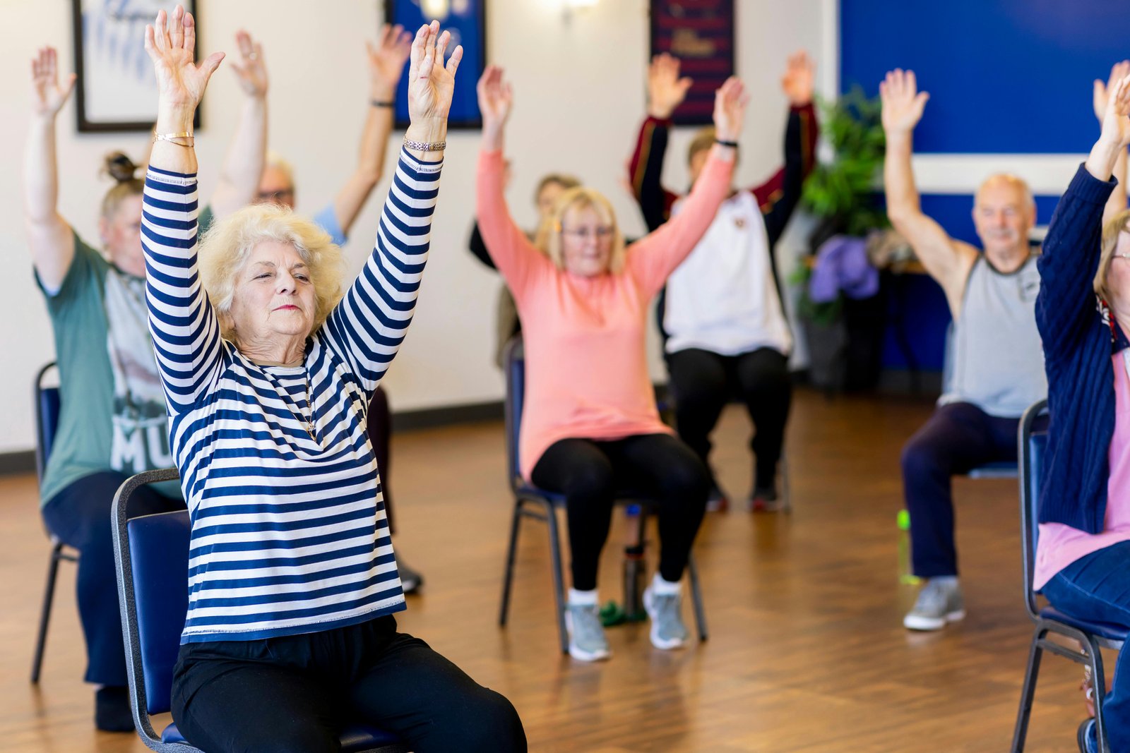 Older adults taking part in a seated balance and movement exercise class