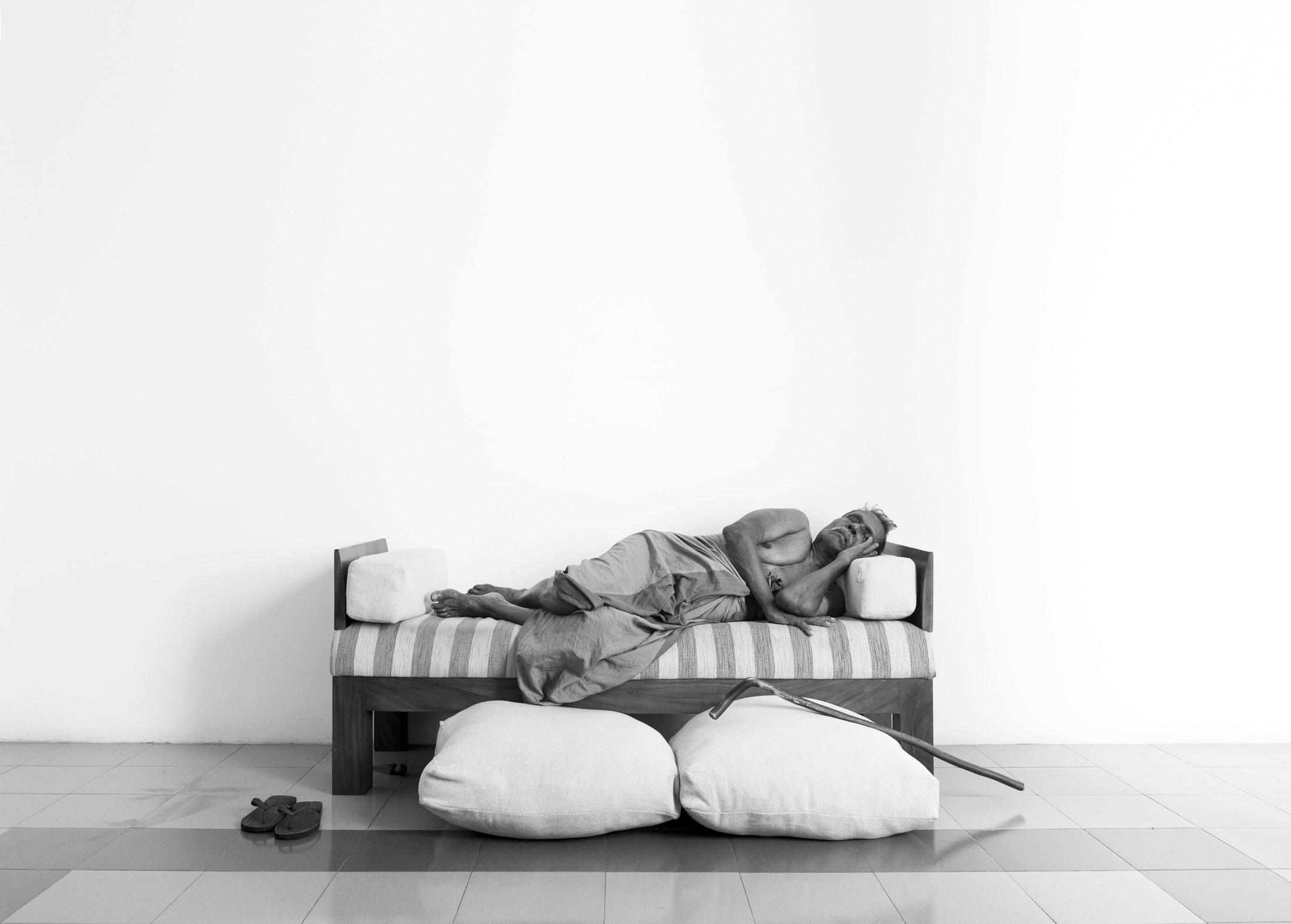 Older adult resting on a couch during the day