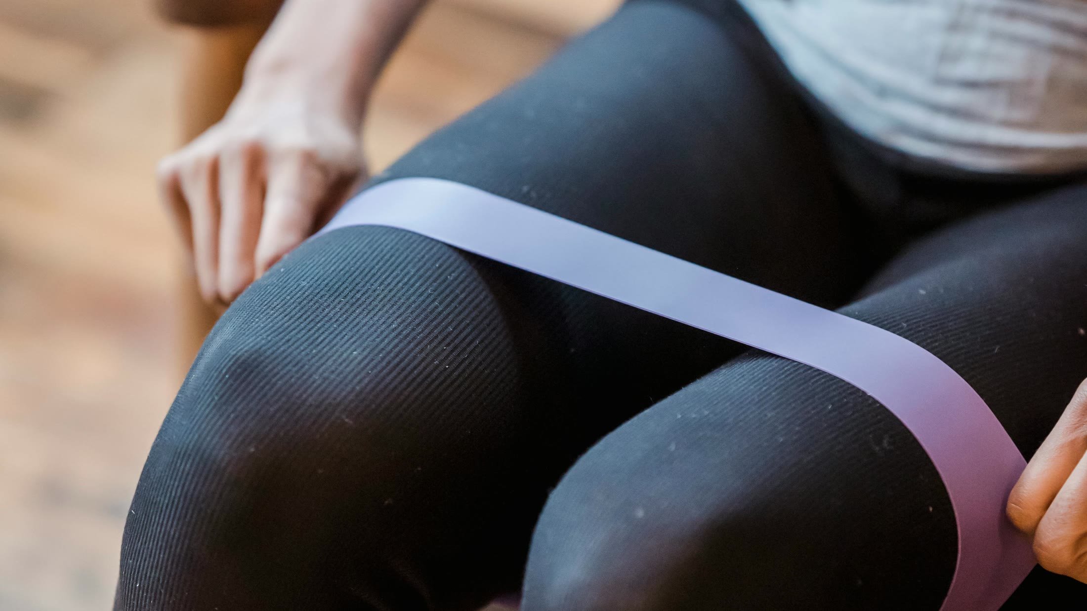 A person using a resistance band during a home strength-training exercise