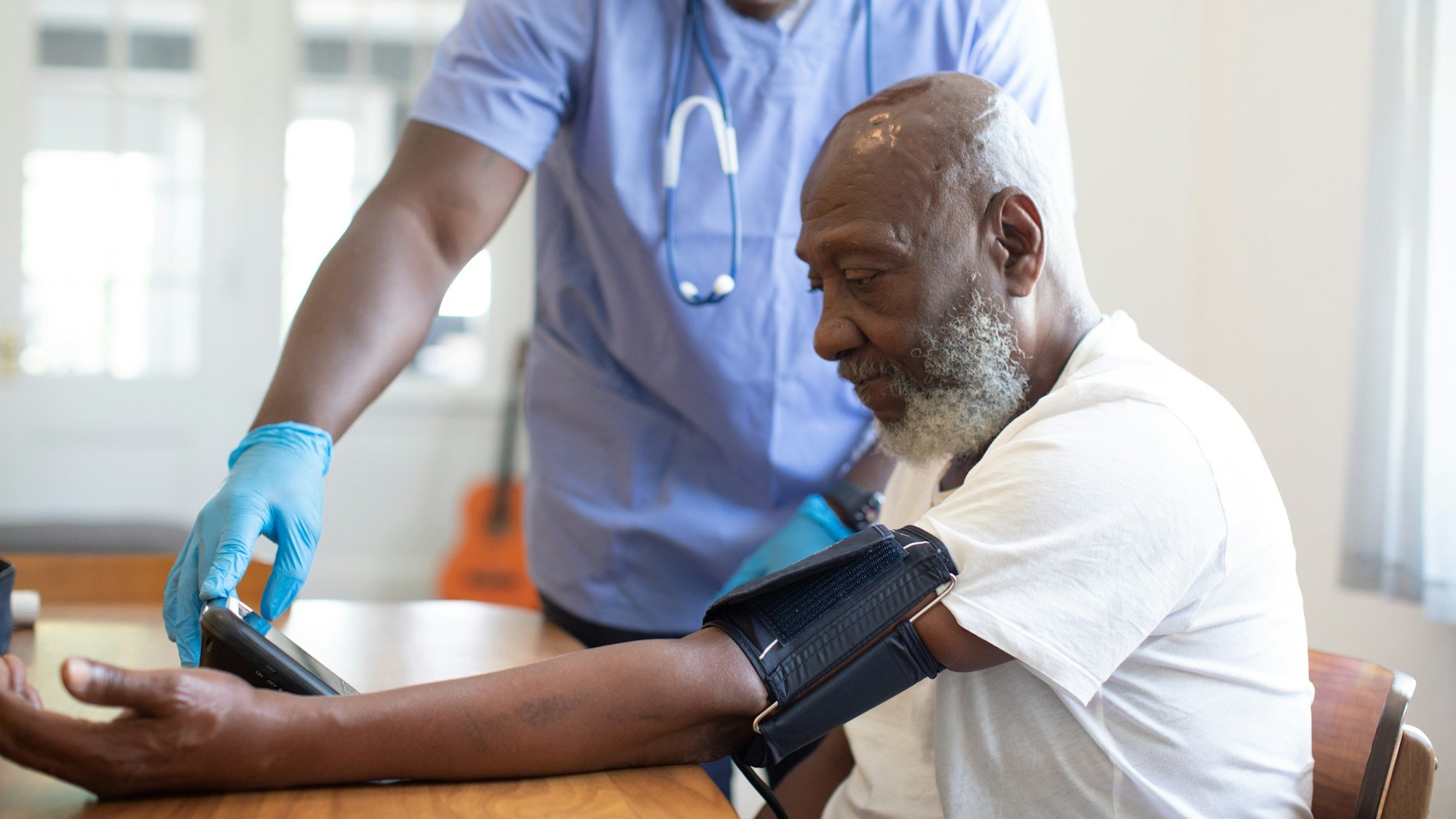 Clinician checking a patient's blood pressure during a health assessment