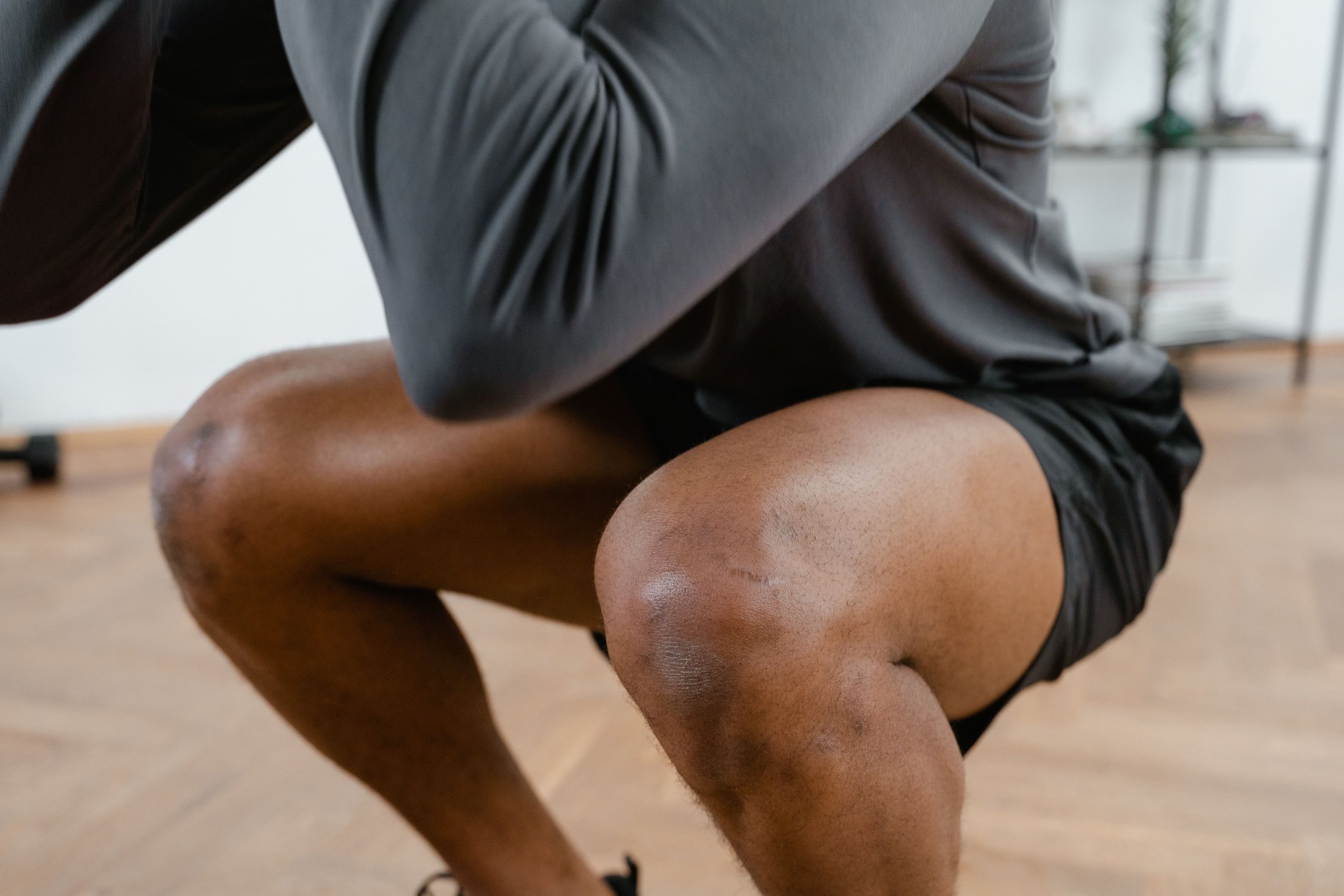 Close-up of a man holding a squat position during isometric exercise