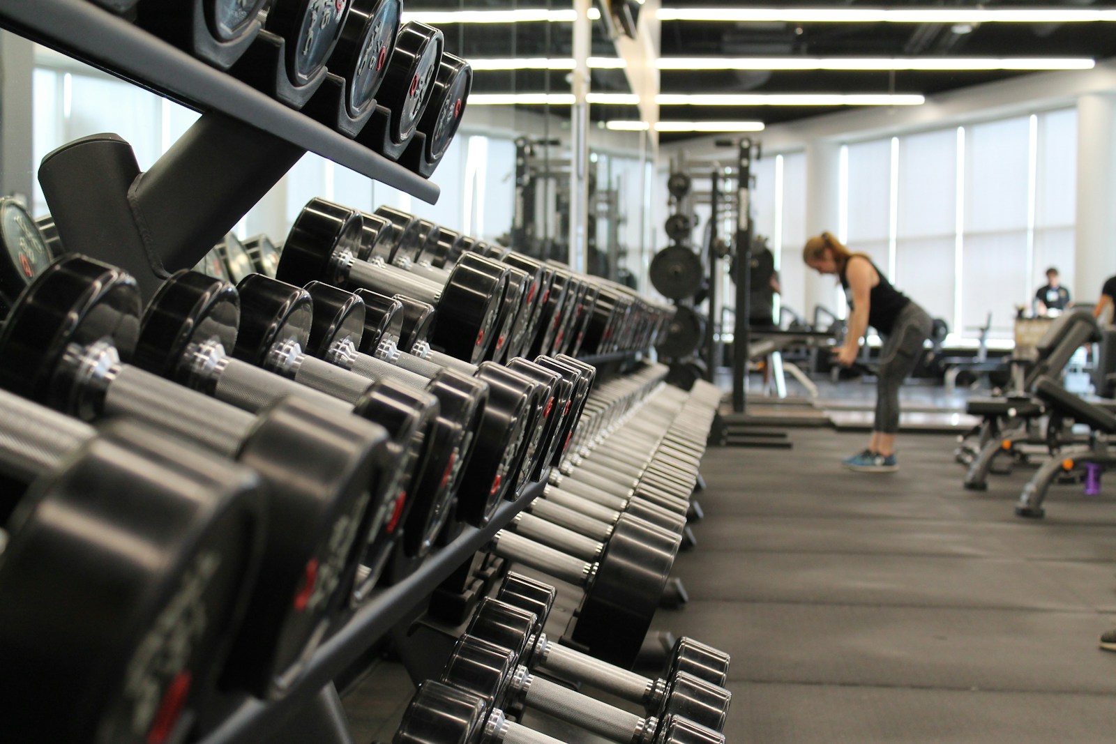 A person strength training with dumbbells