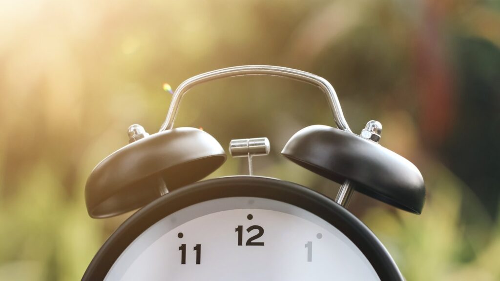 Black and white alarm clock in morning light
