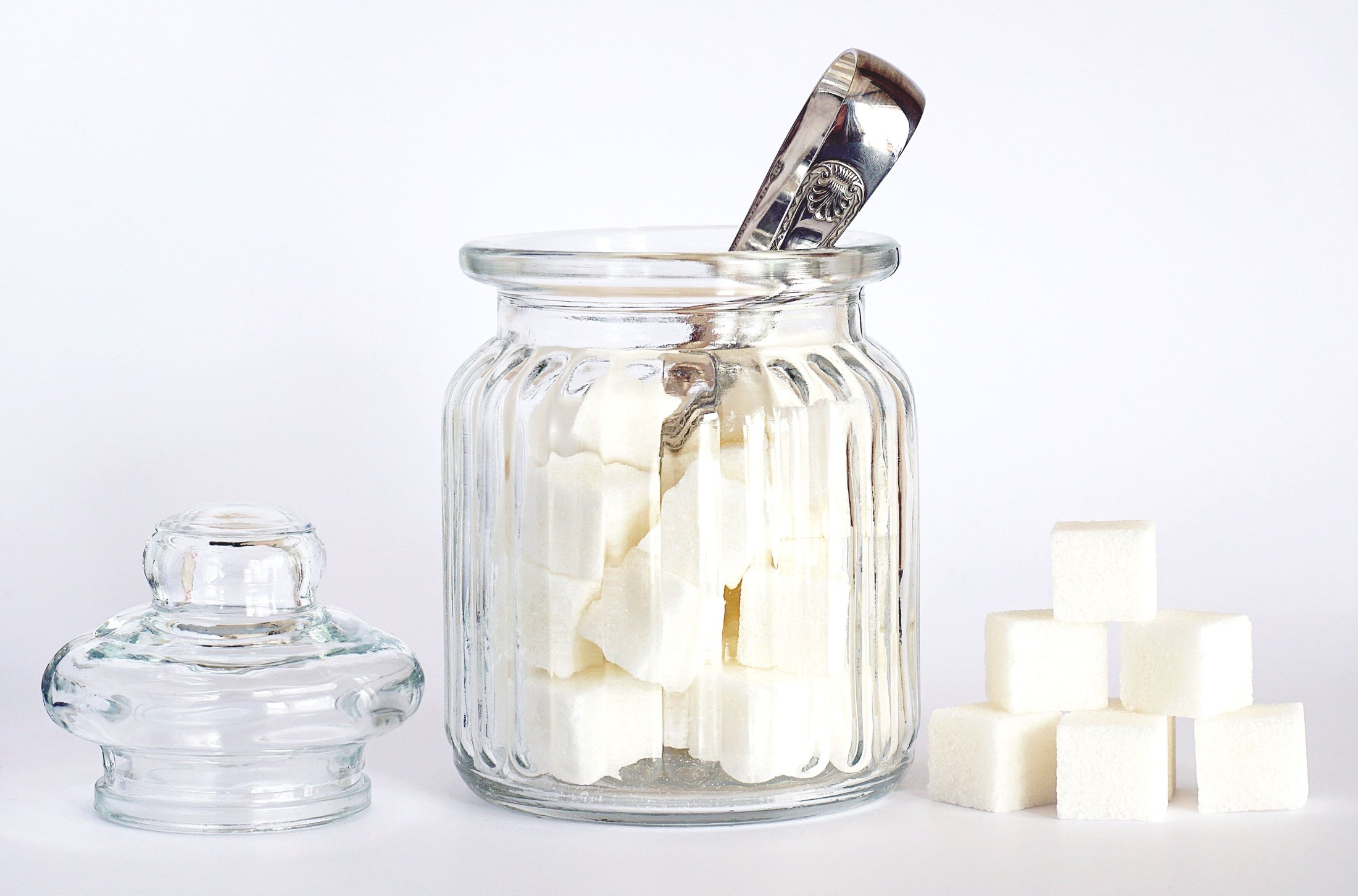 Sugar cubes in a glass jar on a table