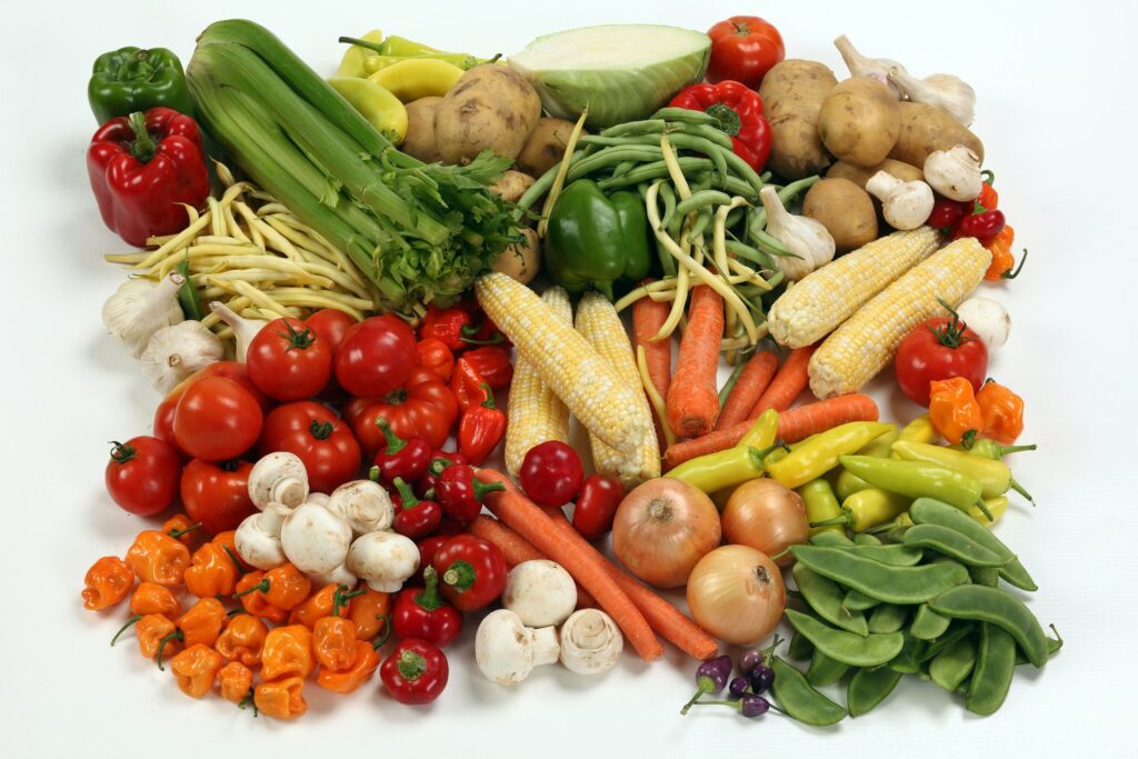Assorted vegetables arranged on a white surface