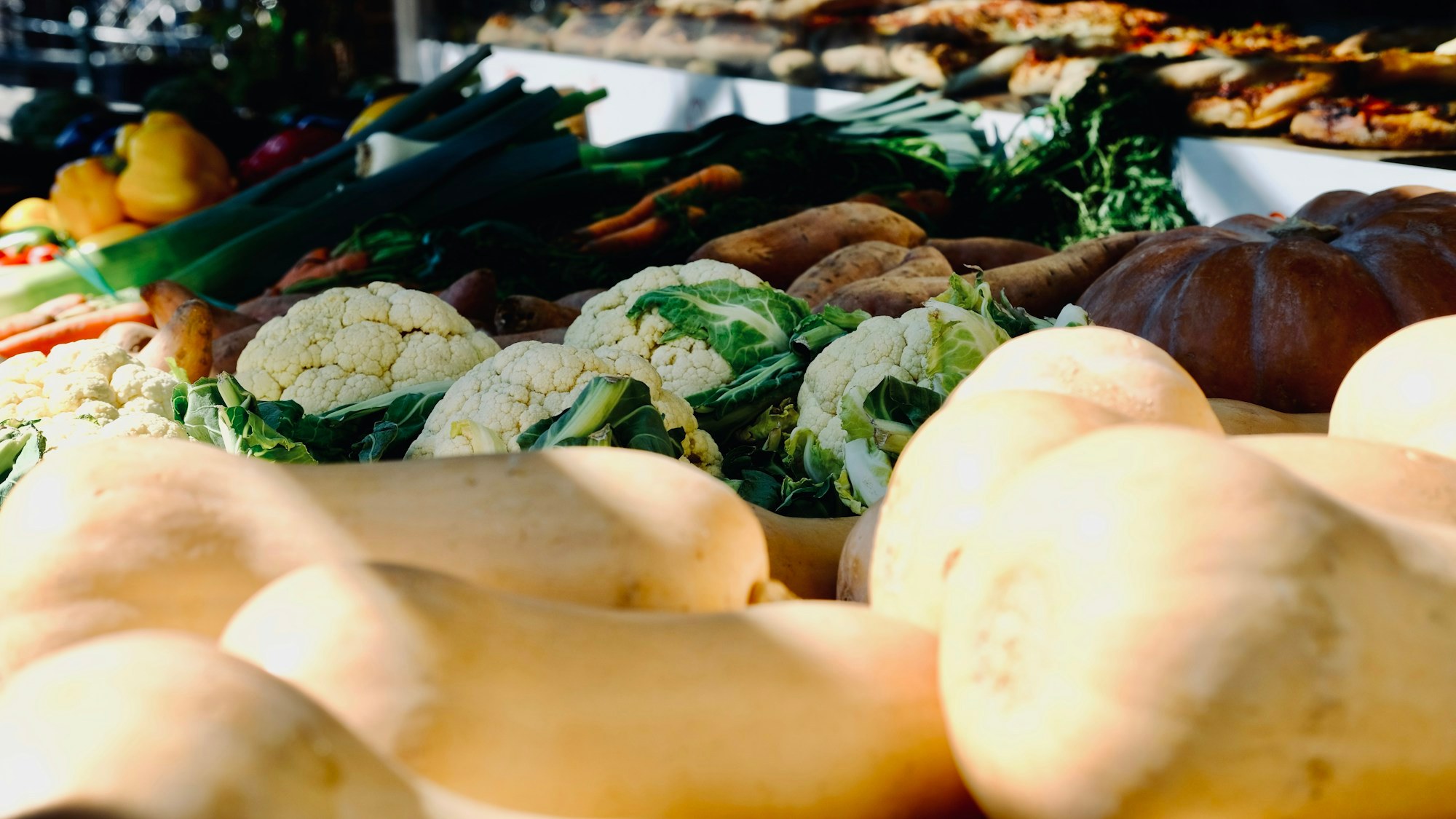 Fresh vegetables and bread displayed at a market stall