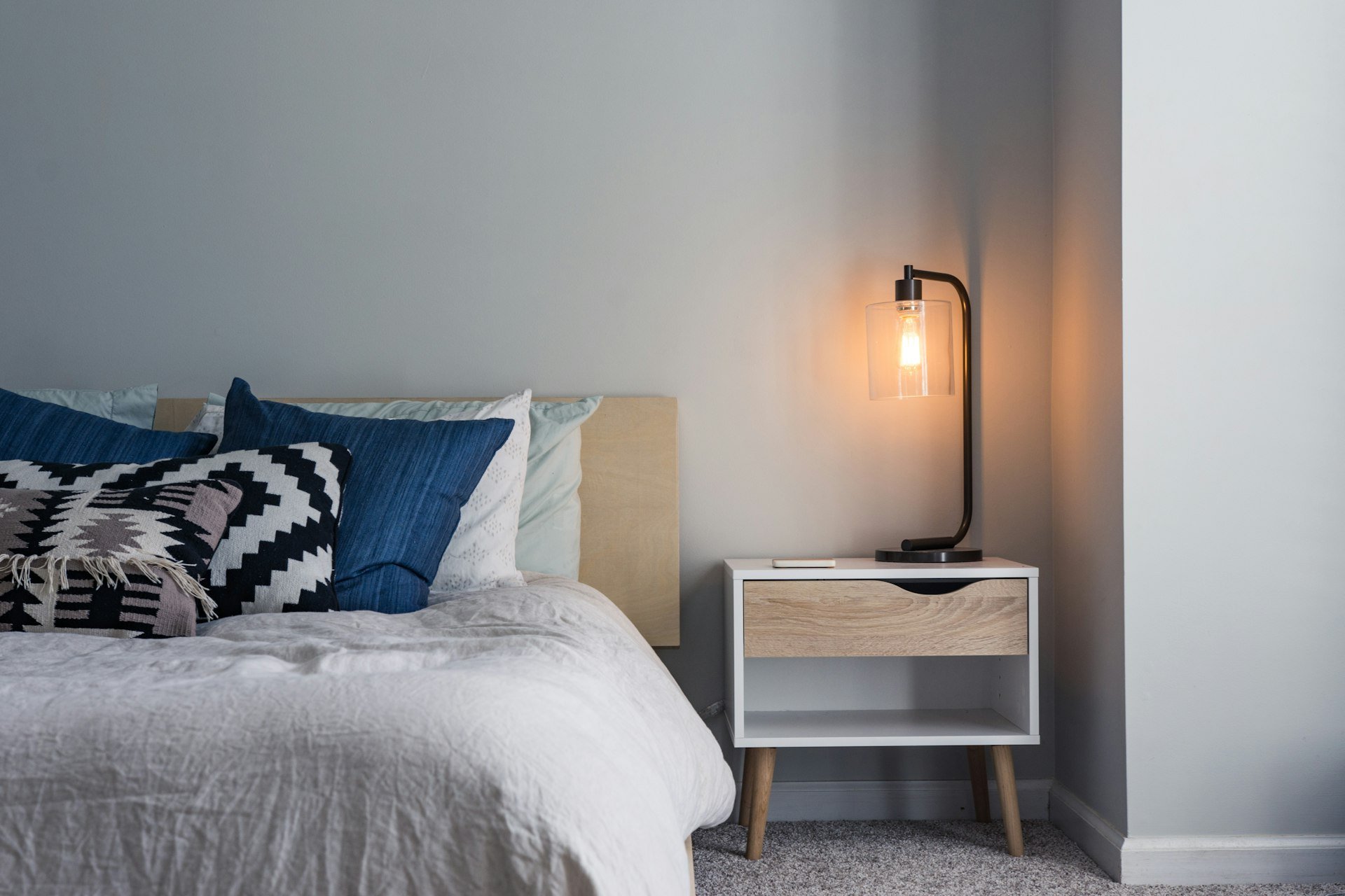 Warm bedside lamp in a dim bedroom at night