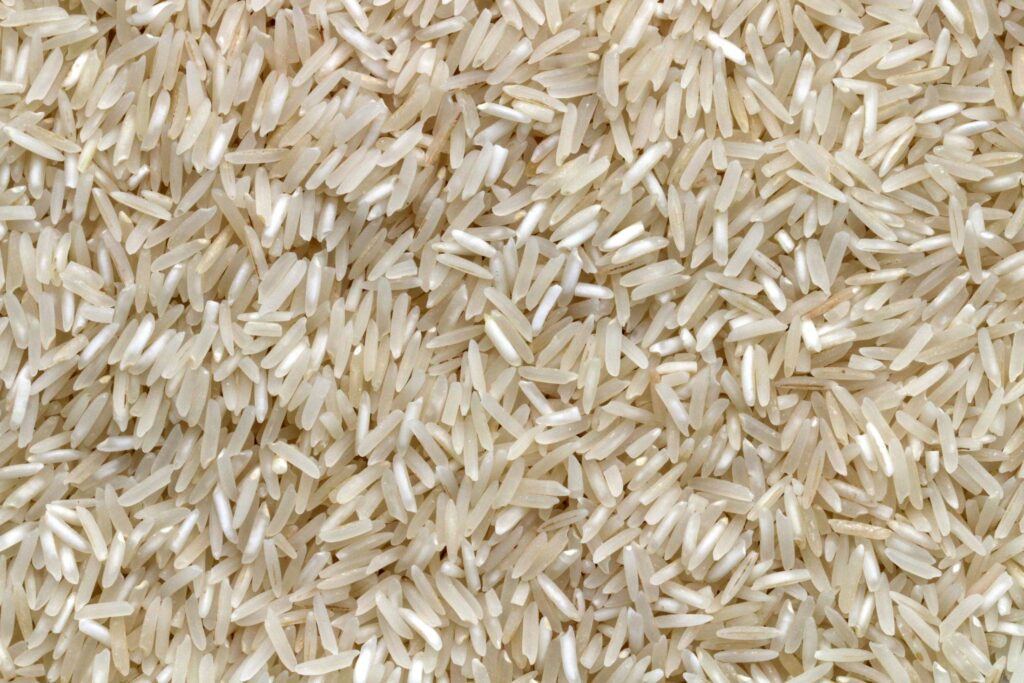 White rice grains on a wooden table
