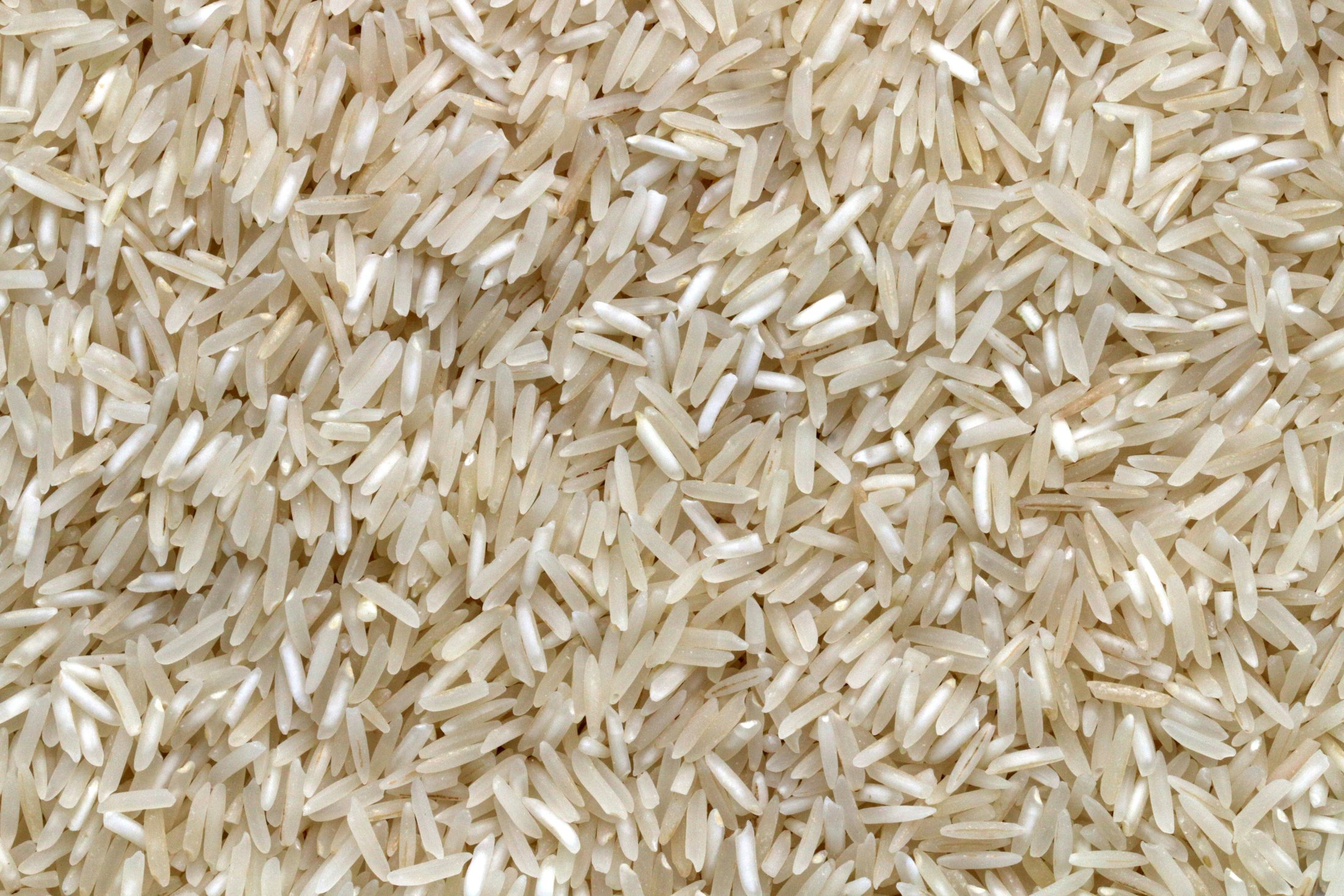 White rice grains on a wooden table