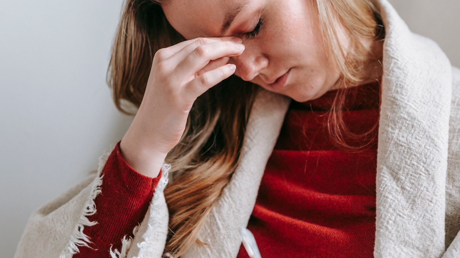 Adult woman holding her head during a migraine episode