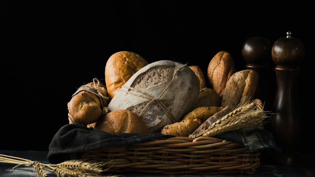 Assorted loaves and bread rolls arranged in a basket