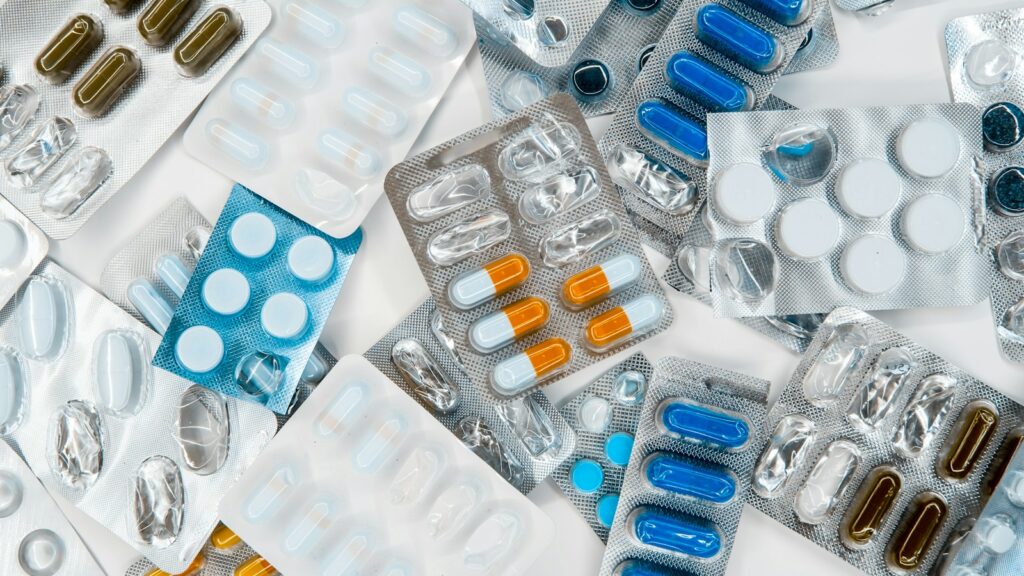 Assorted medicines on a table; illustrative photograph, not identified as melatonin.