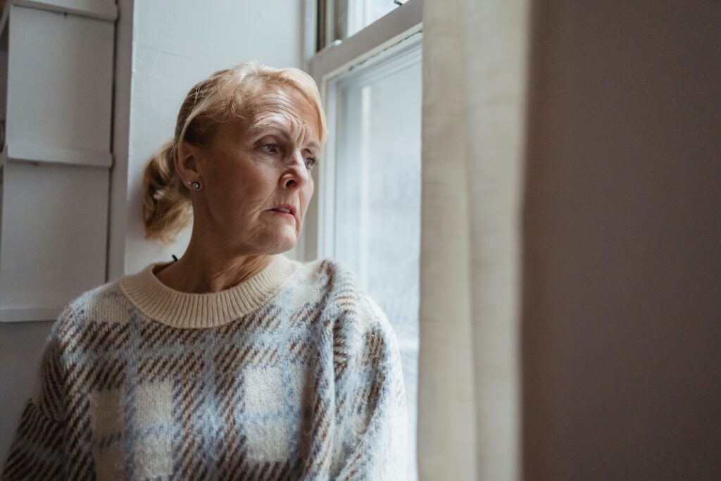 Woman sitting beside a window