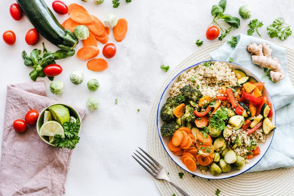 Overhead view of a vegetable salad and assorted foods