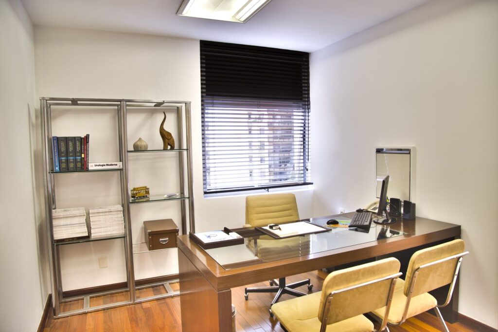 Empty office with a wooden desk and chairs.